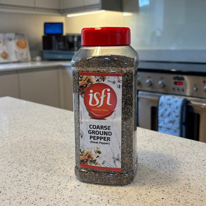 Bottle of Isfi course ground black pepper on a kitchen counter with appliances in the background