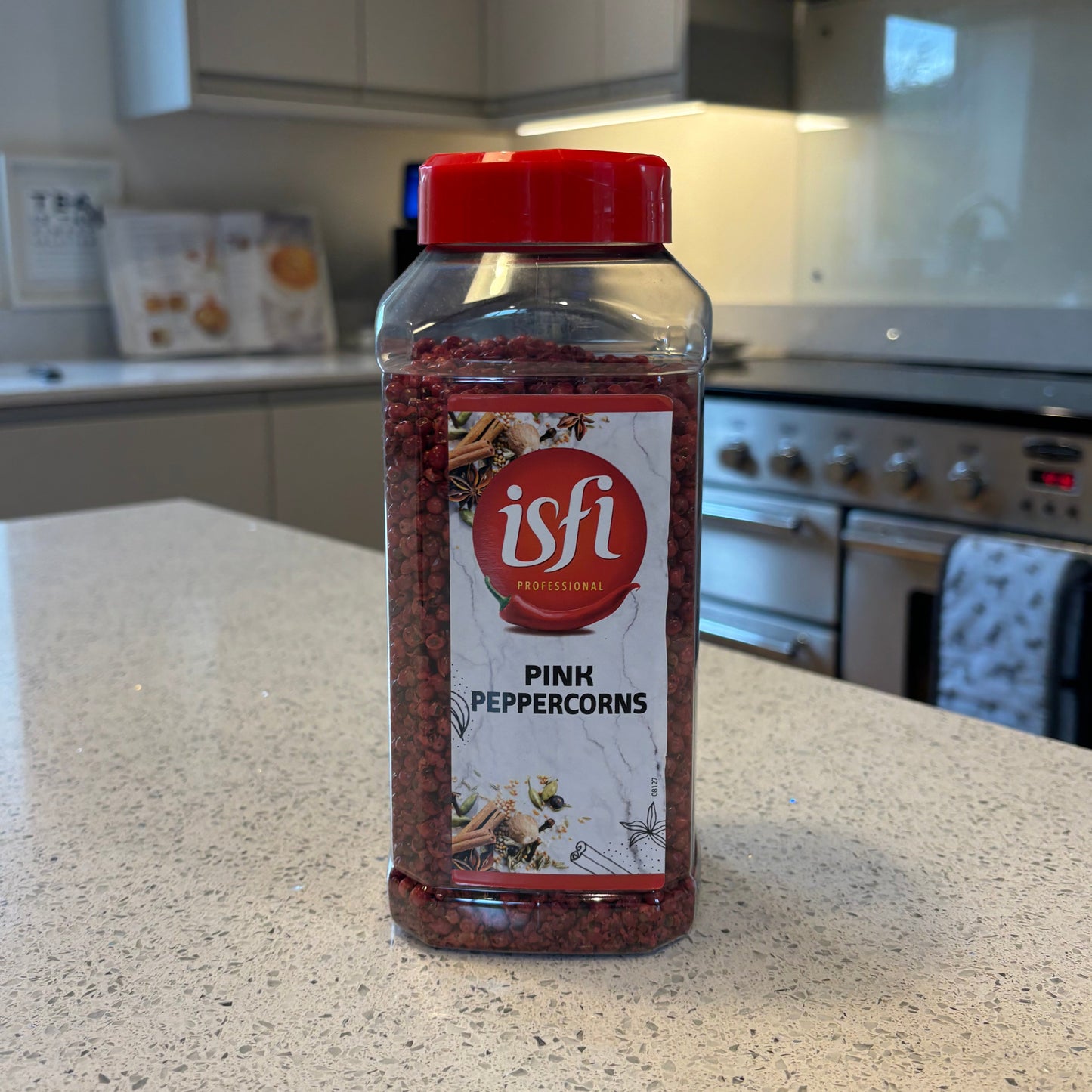 Bottle of Isfi pink peppercorns on a kitchen counter