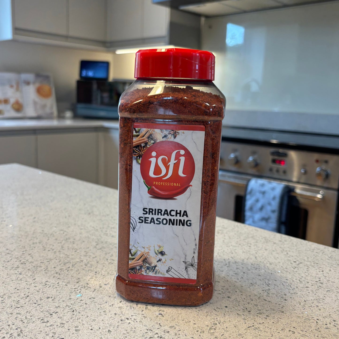 Isfi Sriracha seasoning bottle on a kitchen counter