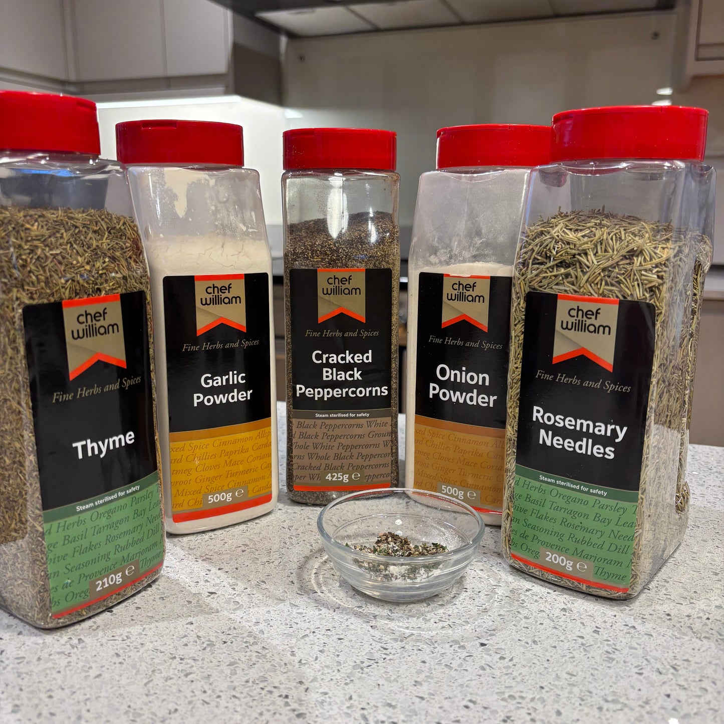 Collection of Chef William spice jars on a kitchen counter